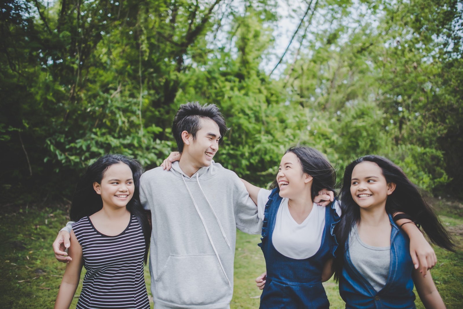 Happy teenage friends smiling outdoors at the park Happy teenage friends smiling outdoors at the park
