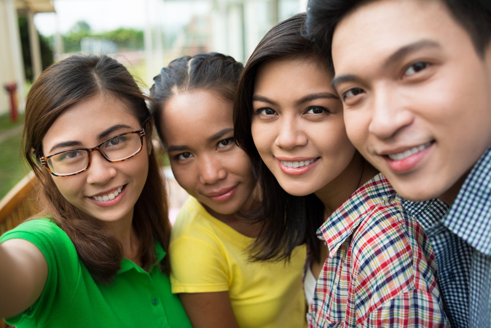 Students taking selfie Hugging smiling Vietnamese students taking selfie together